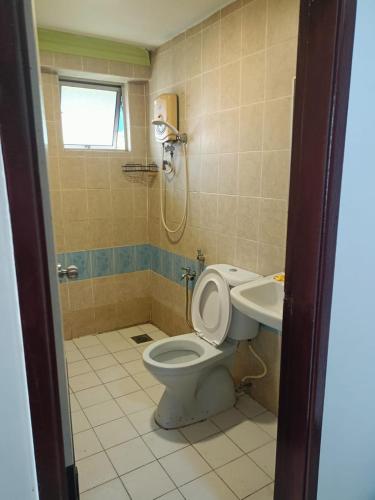 a bathroom with a toilet and a sink at HWKl in Kuala Lumpur
