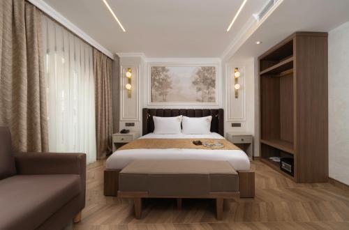 a bedroom with a large bed and a couch at Stern Hotel Karaköy-Special Class in Istanbul