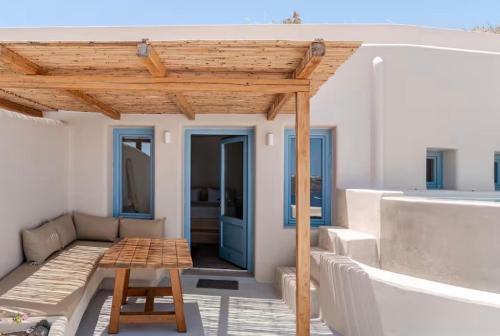 a wooden pergola on a balcony with a table at Akrorama private villas and suites in Akrotiri