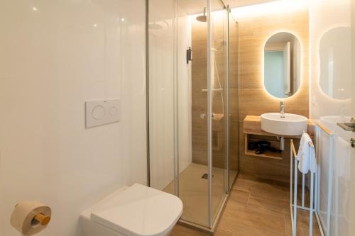 a bathroom with a shower and a toilet and a sink at Letplanet Playa Park in Torremolinos