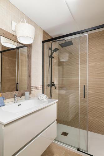a bathroom with a sink and a shower at coto 4 11 in Novo Sancti Petri