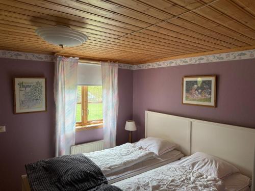 a bedroom with a bed and a wooden ceiling at Ytterbo in Hultsfred