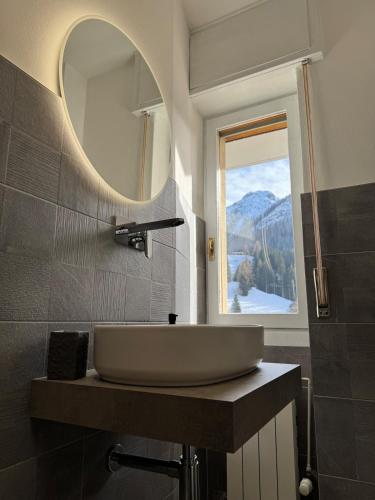 a bathroom with a sink and a mirror at Foppolo GH in Foppolo
