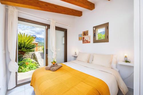 a bedroom with a large bed and a large window at Can Pep in Sóller