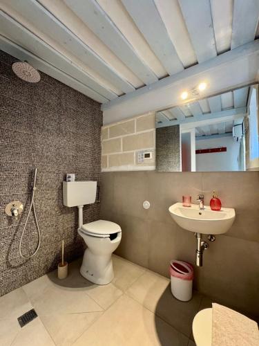 a bathroom with a toilet and a sink at Albergo isola mia in Favignana