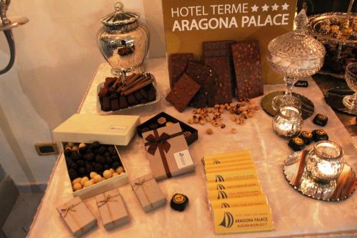 a table topped with boxes of chocolate and other items at Aragona Palace Hotel & Spa in Ischia