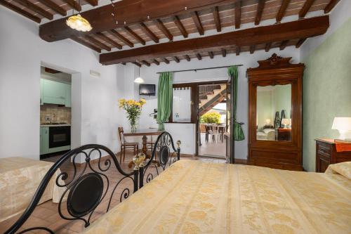 a large bedroom with a bed and a table at Casale Tiziano by PosarelliVillas in Citerna