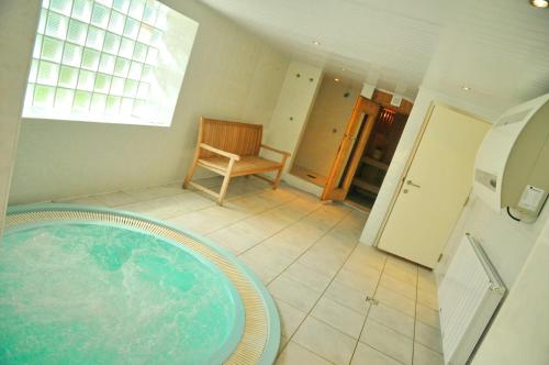 a bathroom with a tub in the middle of a room at Résidence Thier Antoine in Noiseux