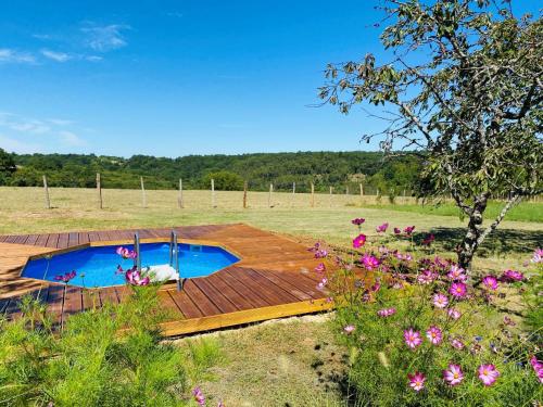 a wooden deck with a swimming pool in a field at PRIVATE POOL with Stunning Views of the Chateau!! Sunset in Rouffignac Saint-Cernin