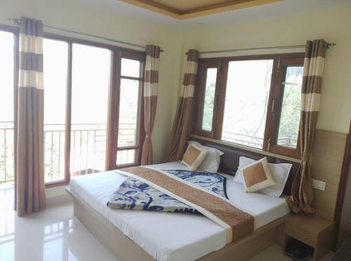 a bedroom with a large bed with windows at Skoon b&b homestay in Shimla