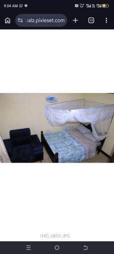 a picture of a room with a bed and chairs at Atié Haven in Lira
