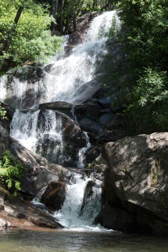 a waterfall in the middle of a river at Casa Rural Romanejo in Cabezabellosa