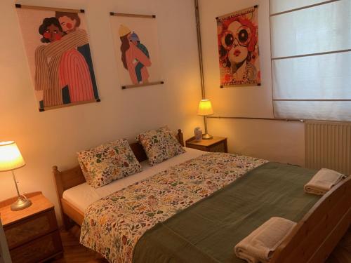 a bedroom with a bed and two pictures on the wall at Tūlevél/Pine-needles in Tata