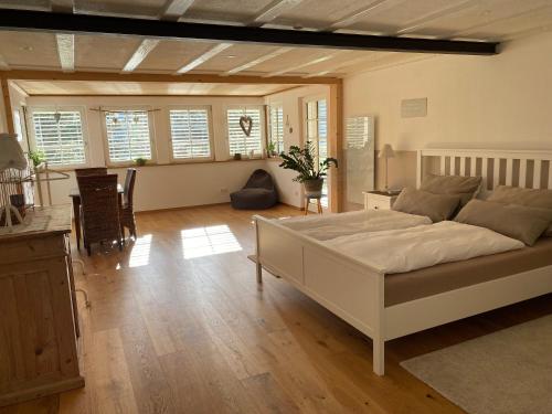 a bedroom with a large white bed in a room at Haus Dekostüble in Münstertal