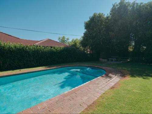a swimming pool in the backyard of a house at Cosy - Best Rest Potch in Potchefstroom
