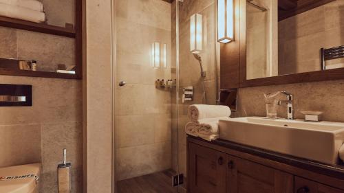 a bathroom with a sink and a shower at Grey Family Hotel in Kopaonik