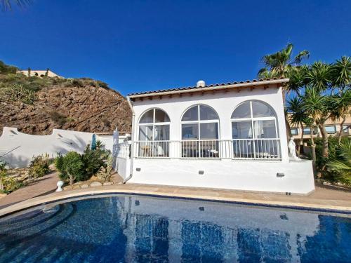 a house with a swimming pool in front of a house at Casa Mar II in Águilas