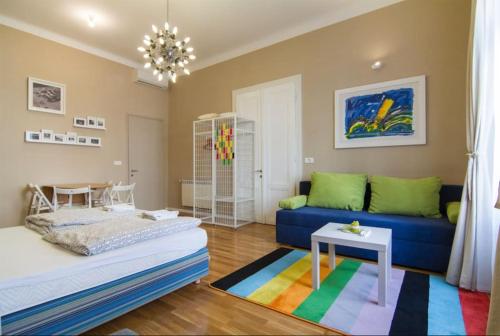 een woonkamer met een blauwe bank en een kleurrijk tapijt bij Apartments Downtown in Zagreb