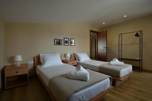 a hotel room with two beds in a room at theaSee Sea & Mountain View in Nea Irakleia