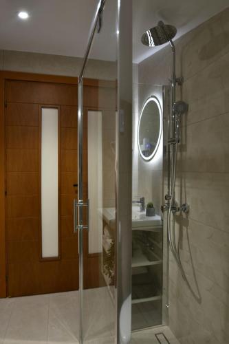 a bathroom with a glass shower with a sink at theaSee Sea & Mountain View in Nea Irakleia
