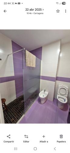 a purple bathroom with a toilet and a bidet at Calle Cañón 9 in Cartagena