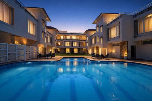 a large swimming pool in front of a building at Devi Palace - Monsoon Palace View Resort, Udaipur in Udaipur