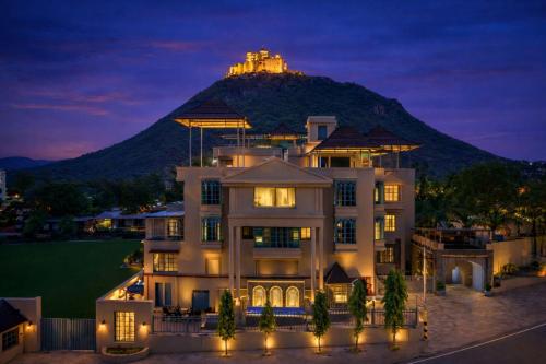 a house with a castle on top of a mountain at Devi Palace - Monsoon Palace View Resort, Udaipur in Udaipur