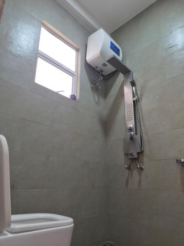 a bathroom with a toilet and a window at Holiday Inn in Colombo
