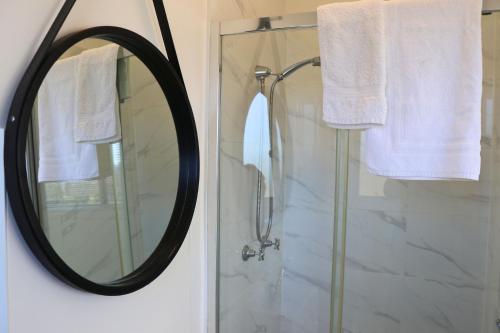 a bathroom with a mirror and a shower at Tangory Farmstay in Glendon Brook