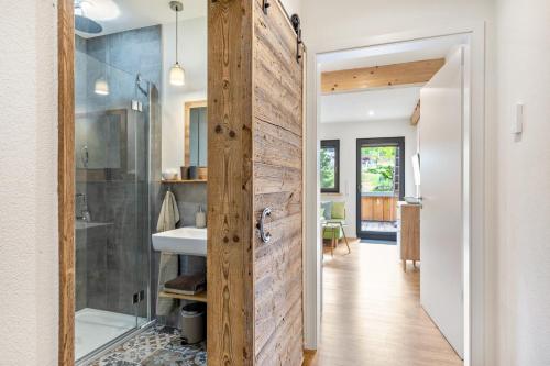 a bathroom with a sliding barn door with a sink at Oberling in Herbrechtingen