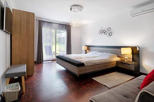a bedroom with a bed and a couch at Casa Carmen in Cabouco