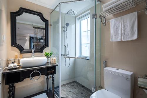 a bathroom with a shower and a sink and a toilet at Sapa Boutique Hotel & Spa in Sapa