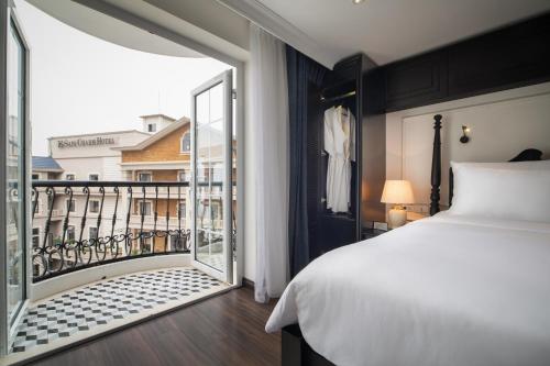a bedroom with a bed and a large window at Sapa Boutique Hotel & Spa in Sapa