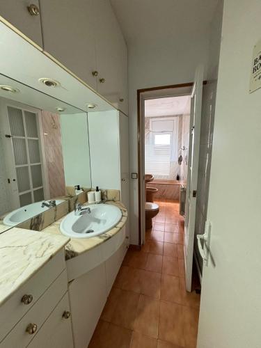 a bathroom with a sink and a large mirror at Vilasardemarlux2 in Vilassar de Mar