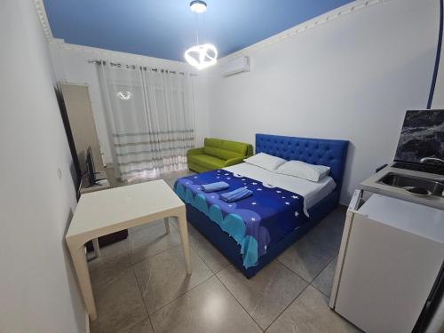 a small room with a bed and a table at Sea&Stay in Shëngjin