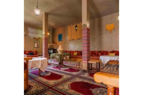 a living room with a couch and a table at Gite Tamlli in Aoufous