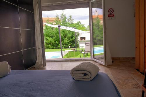 a bedroom with a bed and a large sliding glass door at Finca cataleya in Noez