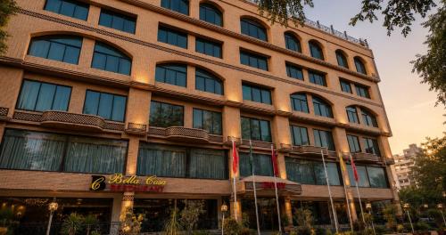 a large building with a hotel sign in front of it at Envoy Continental Hotel, Blue Area, Islamabad in Islamabad