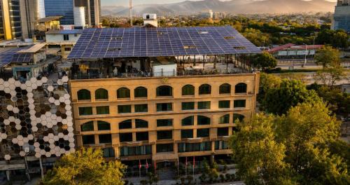 a building with solar panels on top of it at Envoy Continental Hotel, Blue Area, Islamabad in Islamabad