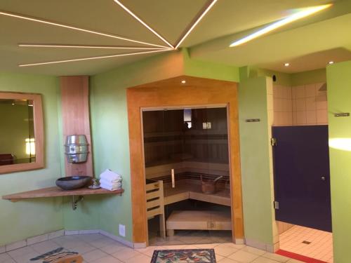 a kitchen with green walls and a ceiling at Landgasthof Zum Schwanen in Hornberg