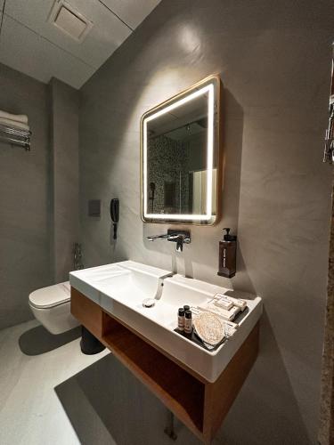 a bathroom with a sink and a toilet at Hotel Imperial Blu in Similigurha