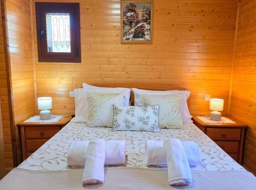 a bedroom with a bed with pillows and two lamps at Casa da Covinha - Branda da Aveleira in Melgaço