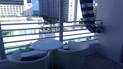 a balcony with a table and a view of a city at Albion Hotel in Miami Beach