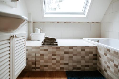 a bathroom with a sink and a tub at Haras de Baudemont in Ittre