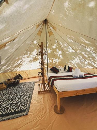 a bedroom with a bed in a tent at Habitat Eco Farm in Sorrento