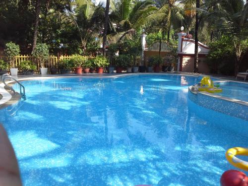 a large pool with blue water in a resort at Elegant Shades in Colva