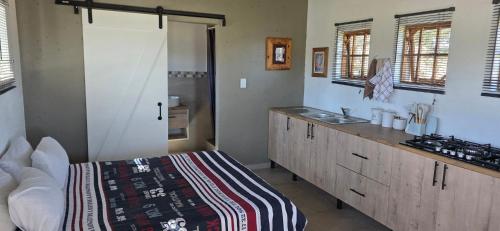a kitchen with a bed and a sink in a room at Mooring Manor Chalet in Vaal Marina