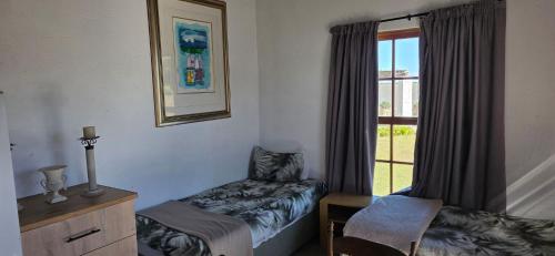 a room with a bed and a window at Mooring Manor Chalet in Vaal Marina