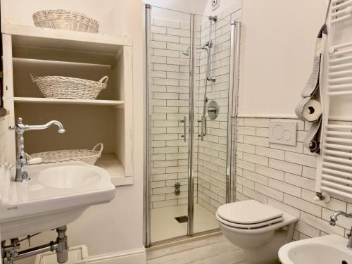 a bathroom with a toilet and a sink and a shower at Casa Mariarosa in Volterra