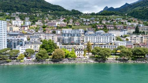 a city on the shore of a body of water at Spacious 3BR Lakeview Apartment with Terrace by GuestLee in Montreux